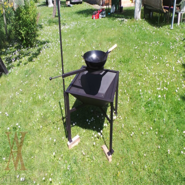 Garden fireplace with the holder for wok frying pan and a copper.